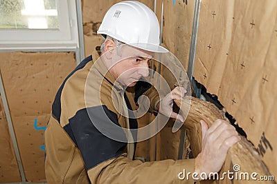 Worker insulates the walls Stock Photo