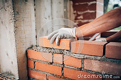 Worker laying bricks on exterior walls Stock Photo