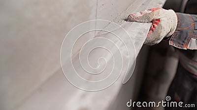 Plasterer at work on construction site, leveling walls and checking quality. Industrial worker on construction site. Worker Stock Photo