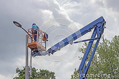 Worker in lift bucket Stock Photo