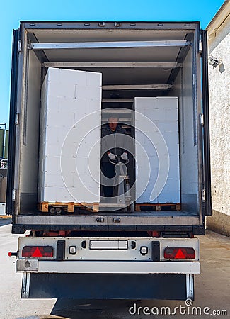 Worker loads semi-truck Stock Photo