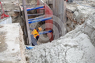 Worker making trench bed for new pipeline construction Stock Photo