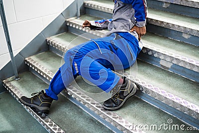 Worker Man Lying On Staircase Stock Photo