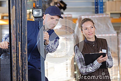 Worker and manager distributing goods in warehouse Stock Photo