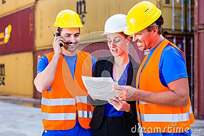 Worker and manager of shipment company discussing Stock Photo