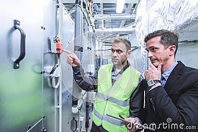 Worker and manager in switchgear room Stock Photo