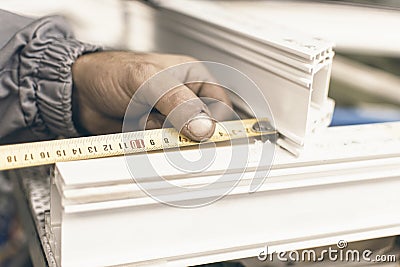 Worker Manufacture Window. Injured Hands From Manual Work and Meter. Plastic Window and Door Industry Production. Stock Photo