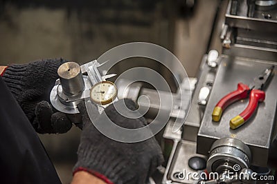 The worker measure the shaft dimension by the dial vernier calliper. Stock Photo