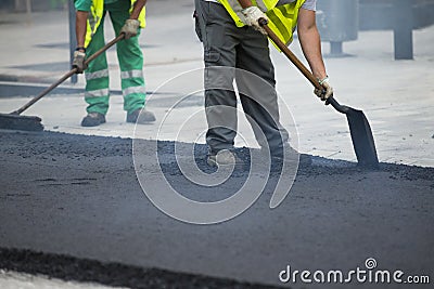 Worker operating asphalt paver machine Stock Photo