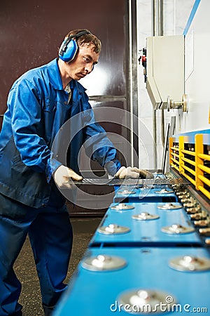 Worker operating guillotine shears machine Stock Photo