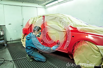 Worker painting a car. Stock Photo