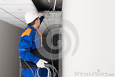 A worker performs technical work on setting up the Internet in homes and offices Stock Photo