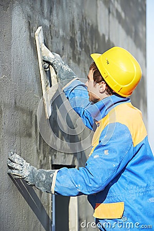 Worker at plastering facade work Stock Photo