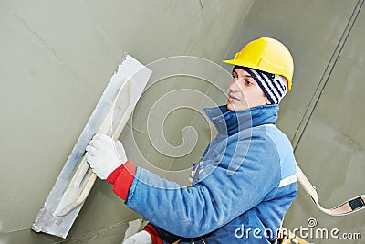 Worker at plastering facade work Stock Photo