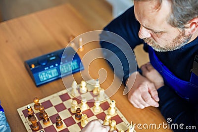 Worker plays chess. Leisure at work. Top view Stock Photo
