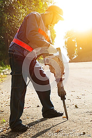 Worker with pneumatic hammer drill equipment Stock Photo