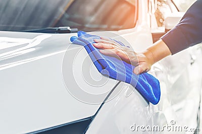 Worker polishing car on a car wash Stock Photo