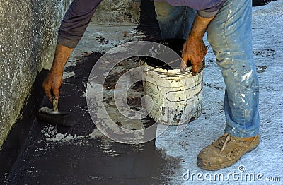 Worker posing with brush bituminous sheath liquid Stock Photo