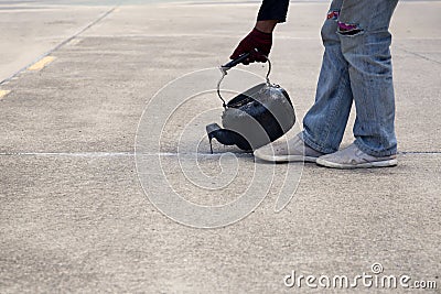 Worker is pouring asphalt for road repair Stock Photo