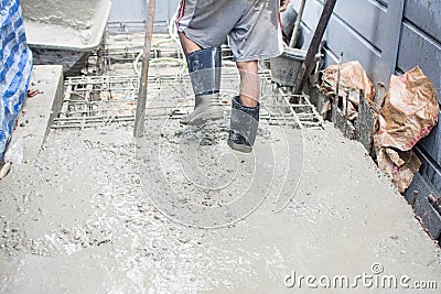 Worker pouring concrete works Stock Photo