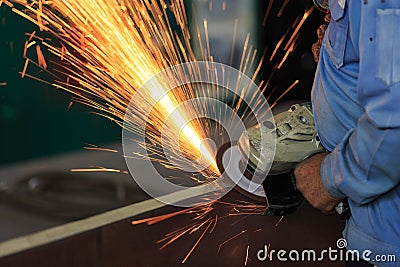 Worker preparation material by hand grinding machine Stock Photo