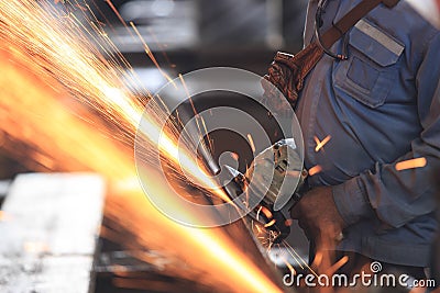 Worker preparation raw materialby hand grinding machine Stock Photo