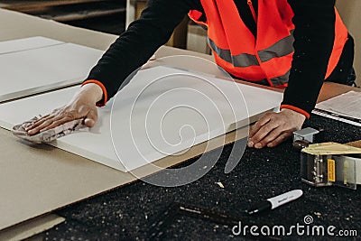 A worker prepares PVC furniture boards for packaging Stock Photo