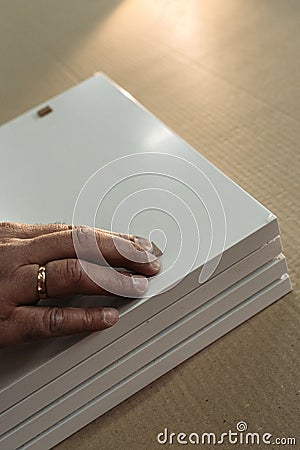 A worker prepares PVC furniture boards for packaging Stock Photo