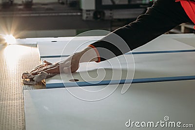 A worker prepares PVC furniture boards for packaging Stock Photo