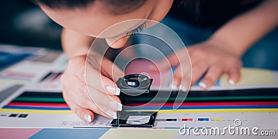 Worker in printing and press centar uses a magnifying glass Stock Photo