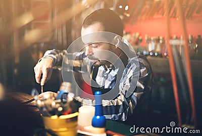 Worker processing leather for belt Stock Photo