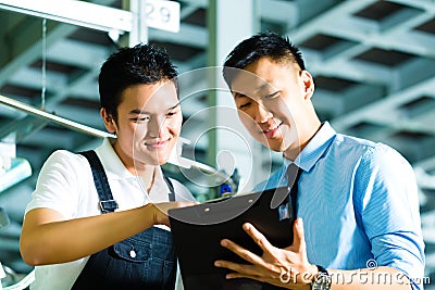 Worker and production manager with Clipboard Stock Photo