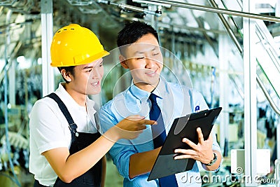 Worker and production manager with Clipboard Stock Photo