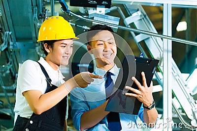 Worker and production manager with Clipboard Stock Photo