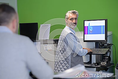 worker or production manager working on computer Stock Photo