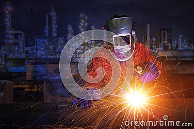 Worker with protective mask welding metal and sparks Stock Photo