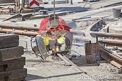 Worker with protective mask welding tram tracks Stock Photo