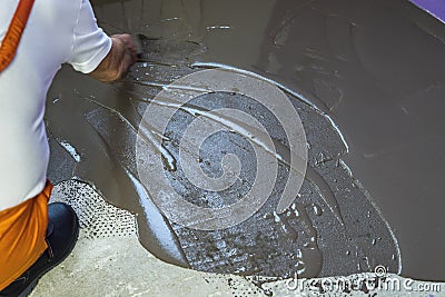 Worker puts a self leveling screed Stock Photo