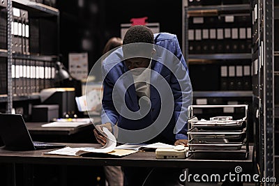Worker reading administrative files Stock Photo