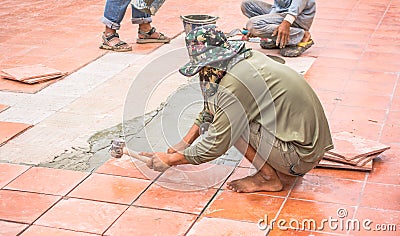 Worker repair floor tile and installation for house building Editorial Stock Photo