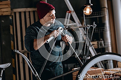 Worker repairing bike Stock Photo