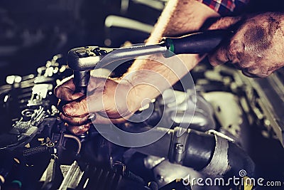 Worker repairs a car in a car repair center Stock Photo