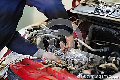 Worker repairs a car Stock Photo