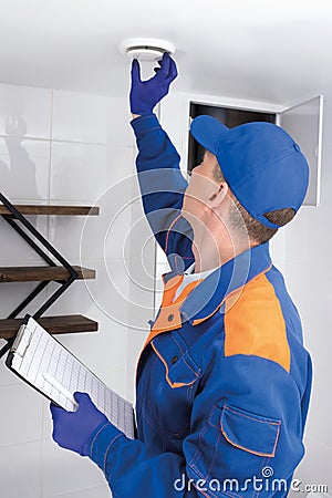 The worker replaces the air filter according to the plan, makes a mark on the check sheet Stock Photo