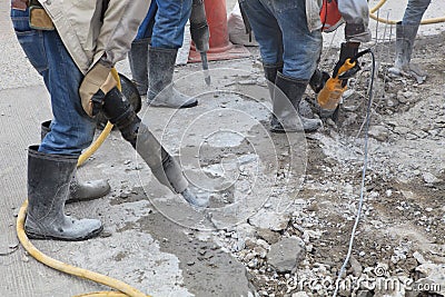 Worker of road construction drilling cement ground Stock Photo