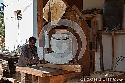 Sur, Oman - November 27 2019 Worker sawing ship planks in traditional dhow wharf in Sur, Oman Editorial Stock Photo