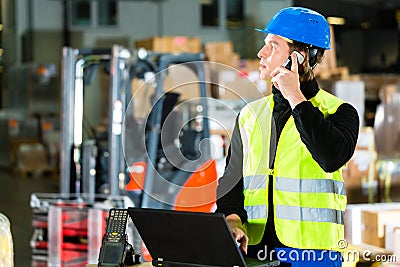 Worker with scanner and laptop at forwarding Stock Photo