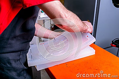 A worker seals the mold for pouring plastic. Manufacturing of plastic products. Medium business concept. Hands close-up Stock Photo