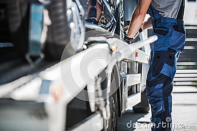 Worker Securing Car on a Towing Truck Stock Photo