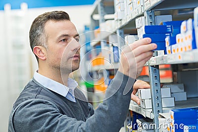 worker selecting package from racking in storeroom Stock Photo